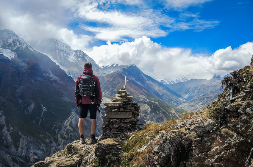 man standing on the clif and looking at beautiful view